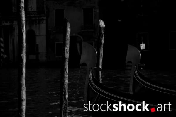 Venetian gondola tied to a wooden pole, black and white photo, stock image, stockshock.art, jowita niemczyk